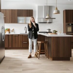 Woman in modern kitchen with wooden cabinets.